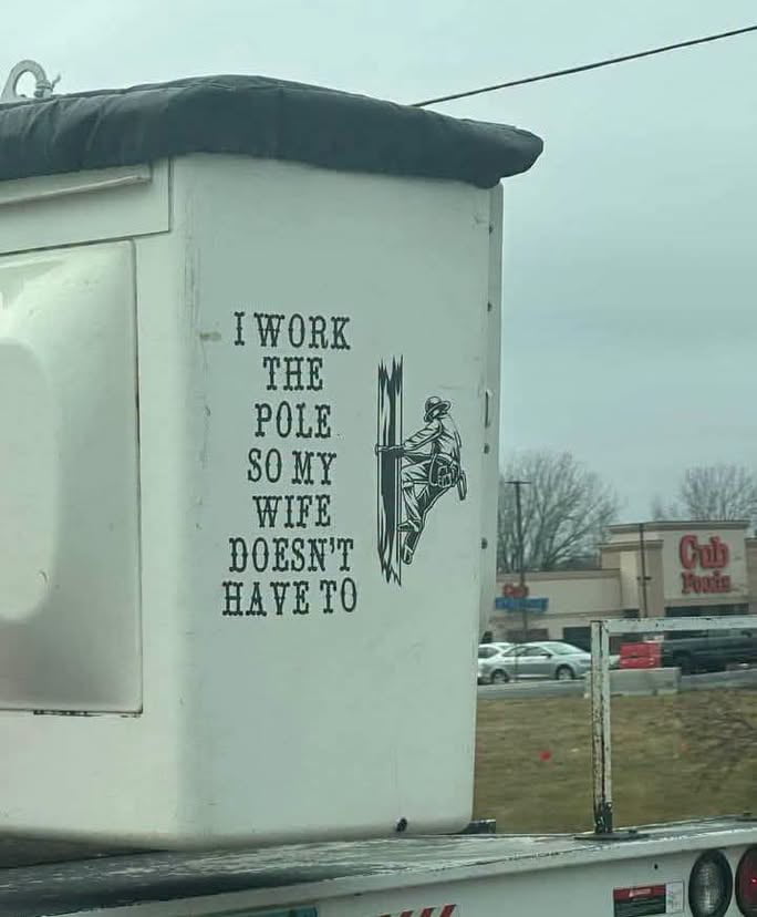 Utility Worker's Humorous Decal on Bucket Truck
