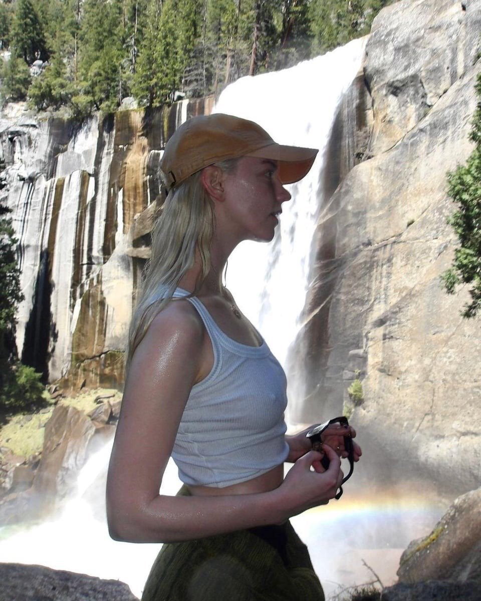 A Hiker Poses for a Photo in Front of a Waterfall - Interesting on Aviaclip