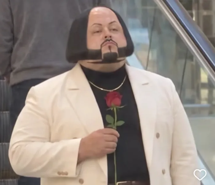 A Man With a Distinctive Hairstyle and Facial Hair Holds a Single Red Rose - Funny on Aviaclip