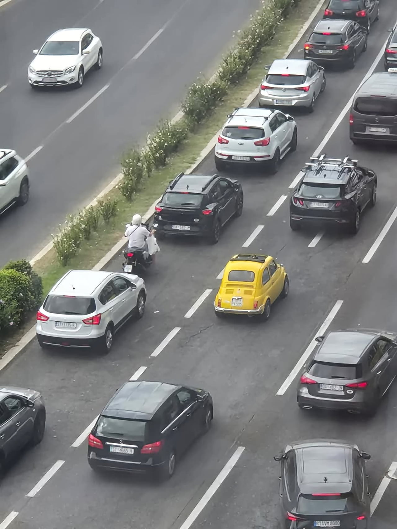 A vintage Fiat 500 stands out in modern traffic - Interesting on Aviaclip