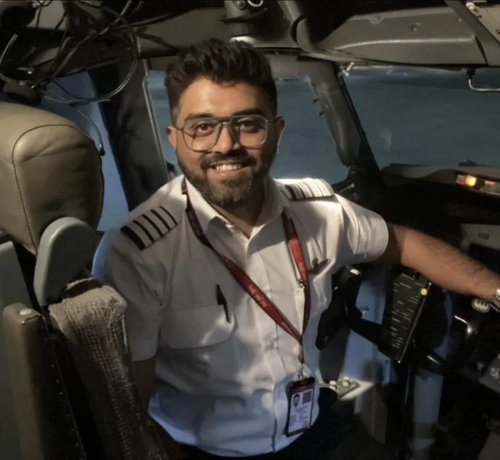 Airline Pilot Poses for Photo in Cockpit