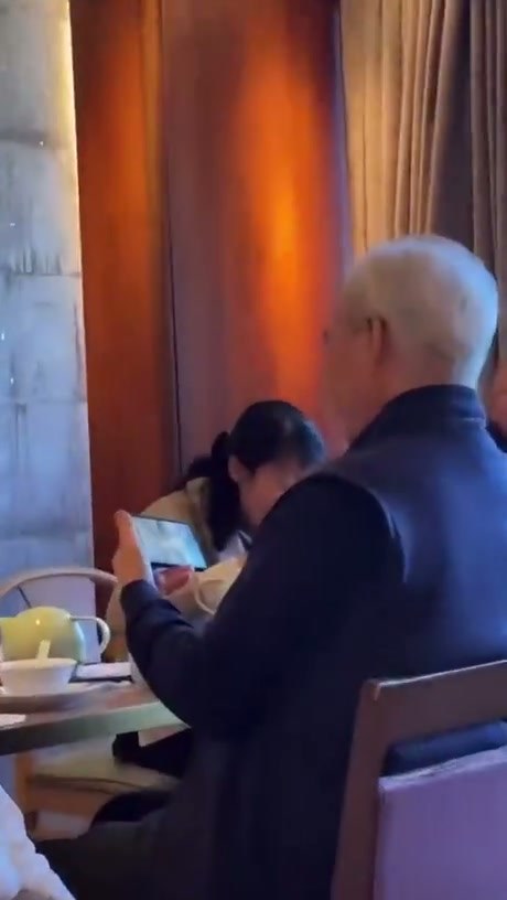 Diner Unfazed While Watching Video During Meal