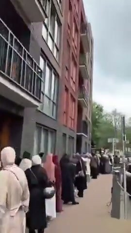 Long Queue Observed Outside Building in Urban Setting