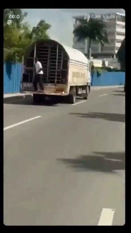 Man Attempts Risky Jump from Moving Truck