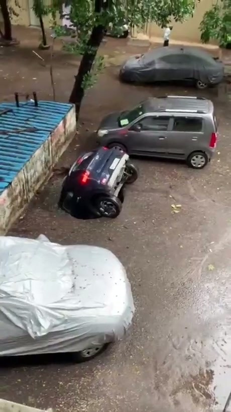 Car Suddenly Vanishes Into A Sinkhole During Heavy Rain