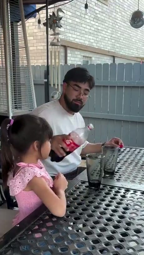 Father and Daughter Share a Drink on the Patio