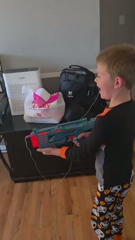 Young Boy Uses Toy Blaster to Remove Loose Tooth