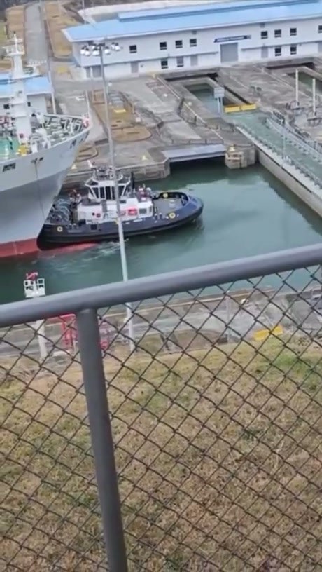 Tugboat Assists Cargo Ship in Panama Canal Lock
