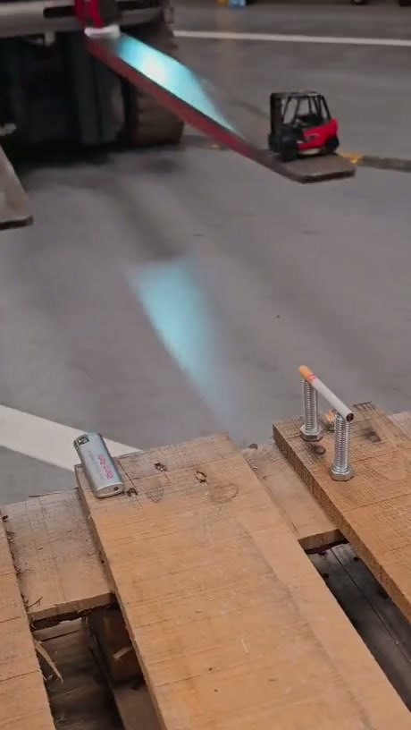 Precision Forklift Skills: Lighting a Cigarette with a Toy