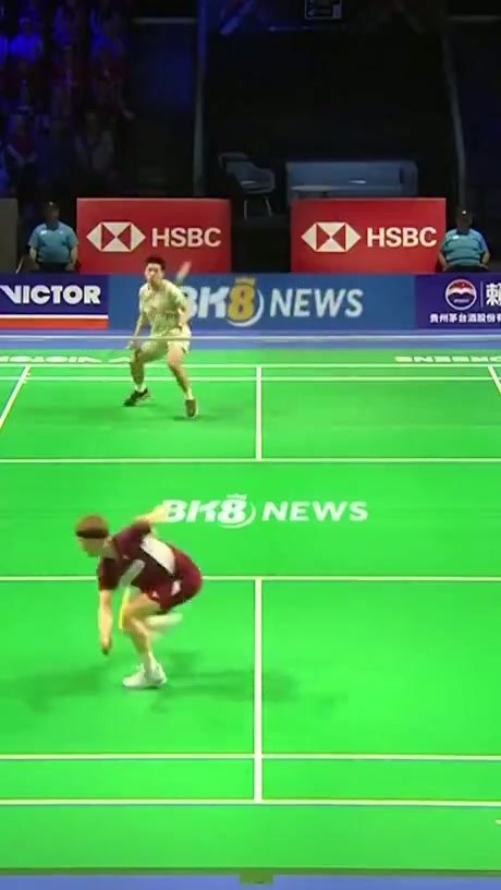 Professional Badminton Player Catches Shuttlecock Mid-Match